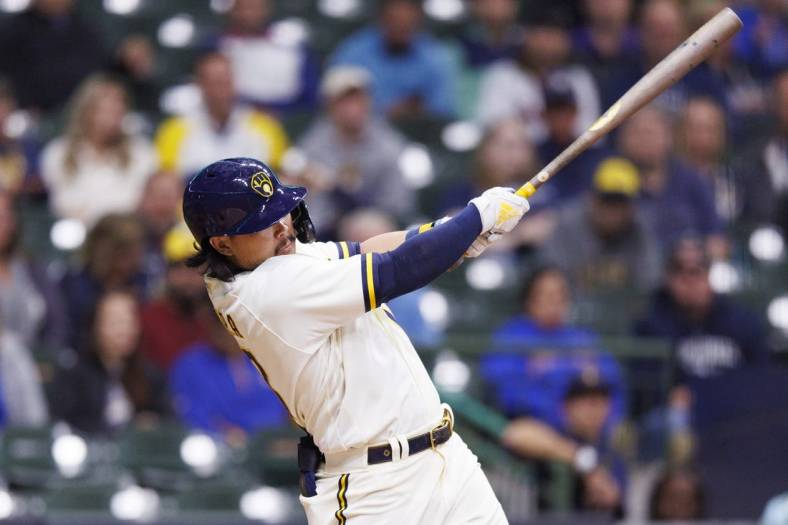 Sep 29, 2022; Milwaukee, Wisconsin, USA;  Milwaukee Brewers first baseman Keston Hiura (18) hits an RBI double during the second inning against the Miami Marlins at American Family Field. Mandatory Credit: Jeff Hanisch-USA TODAY Sports