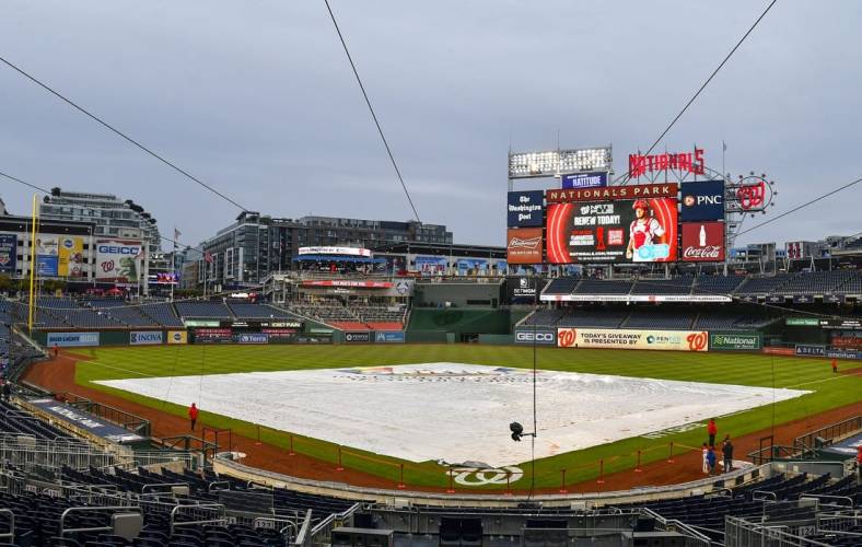 Sep 30, 2022; Washington, District of Columbia, USA; The tarp covers the field before the game between the Washington Nationals and the Philadelphia Phillies at Nationals Park. Mandatory Credit: Brad Mills-USA TODAY Sports