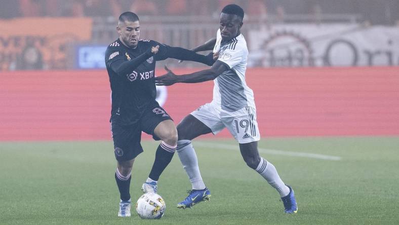 Sep 30, 2022; Toronto, Ontario, CAN; Toronto FC defender Richie Laryea (19) battles for the ball with Inter Miami midfielder Alejandro Pozuelo (8) during the first half at BMO Field. Mandatory Credit: Nick Turchiaro-USA TODAY Sports