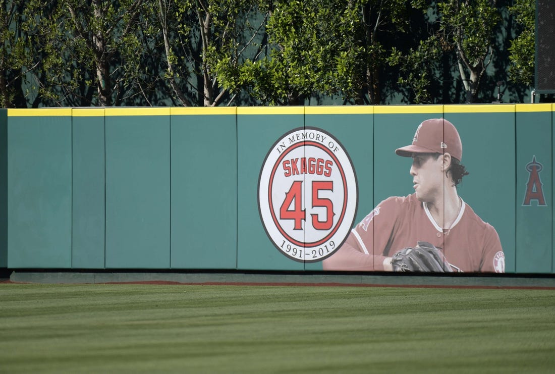 Jul 17, 2019; Anaheim, CA, USA; Detailed view of a memorial for Los Angeles Angels pitcher Tyler Skaggs on the outfield wall  at Angel Stadium of Anaheim. Skaggs, 27, died at a hotel in Southlake, Texas, July 1, 2019, where he was found unresponsive prior to a game against the Texas Rangers. Mandatory Credit: Kirby Lee-USA TODAY Sports