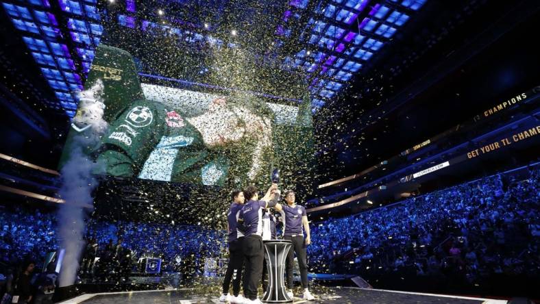 Aug 25, 2019; Detroit, MI, USA; Team Liquid celebrate and lift the trophy after winning the LCS Summer Finals event against Cloud9 at Little Caesars Arena. Mandatory Credit: Raj Mehta-USA TODAY Sports