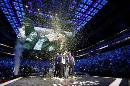 Aug 25, 2019; Detroit, MI, USA; Team Liquid celebrate and lift the trophy after winning the LCS Summer Finals event against Cloud9 at Little Caesars Arena. Mandatory Credit: Raj Mehta-USA TODAY Sports