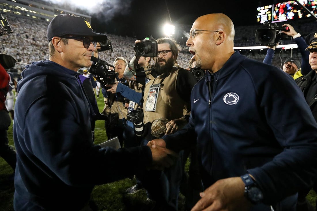 Oct 19, 2019; University Park, PA, USA; Penn State Nittany Lions head coach James Franklin (right) shakes hand with Michigan Wolverines head coach Jim Harbaugh (left) following the completion of the game at Beaver Stadium. Penn State defeated Michigan 28-21. Mandatory Credit: Matthew O'Haren-USA TODAY Sports