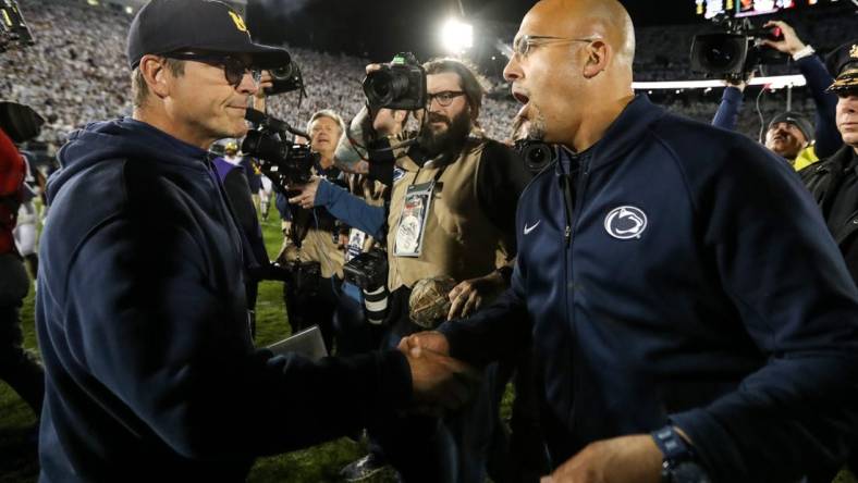 Oct 19, 2019; University Park, PA, USA; Penn State Nittany Lions head coach James Franklin (right) shakes hand with Michigan Wolverines head coach Jim Harbaugh (left) following the completion of the game at Beaver Stadium. Penn State defeated Michigan 28-21. Mandatory Credit: Matthew O'Haren-USA TODAY Sports