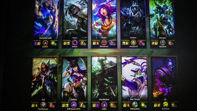 The loading screen for League of Legends is seen projected on the wall behind the competitors. The loading screen comes up while waiting for the game to start, allowing players to view each characters basic information before the battle. Jan. 24, 2020