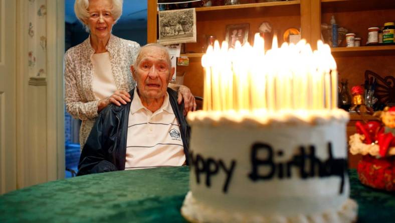 Dec 14, 2020; Athens, GA, USA; UGA football legend, and the oldest living UGA Pro Football Hall of Famer, Charley Trippi celebrated his 99th birthday with his wife Peggy at their home in Athens on Monday. They admire a cake, made by Joyce Phillips of Winterville, with 99 candles lit atop. Mandatory Credit: Joshua L. Jones-USA TODAY NETWORK