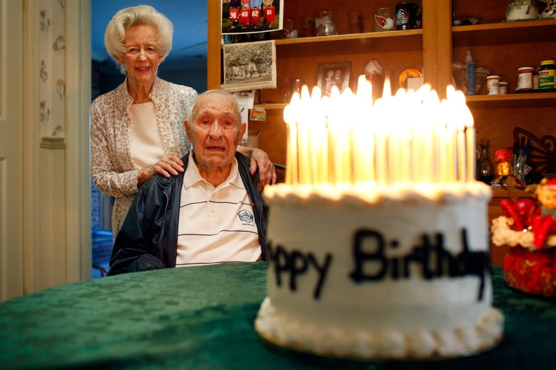 Dec 14, 2020; Athens, GA, USA; UGA football legend, and the oldest living UGA Pro Football Hall of Famer, Charley Trippi celebrated his 99th birthday with his wife Peggy at their home in Athens on Monday. They admire a cake, made by Joyce Phillips of Winterville, with 99 candles lit atop. Mandatory Credit: Joshua L. Jones-USA TODAY NETWORK