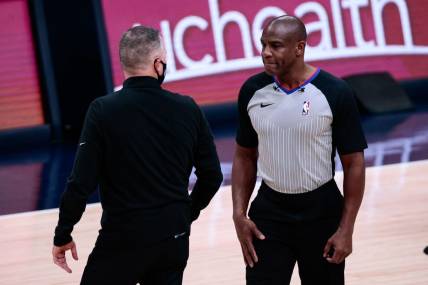 Dec 23, 2020; Denver, Colorado, USA; Denver Nuggets head coach Michael Malone (L) argues a call with referee Tony Brown (R) in the first quarter against the Sacramento Kings at Ball Arena. Mandatory Credit: Isaiah J. Downing-USA TODAY Sports