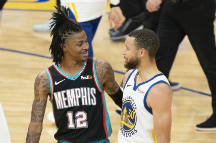 May 16, 2021; San Francisco, California, USA; Memphis Grizzlies guard Ja Morant (12) talks to Golden State Warriors guard Stephen Curry (30) after the game at Chase Center. Mandatory Credit: Kyle Terada-USA TODAY Sports