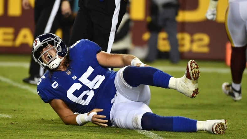 Sep 16, 2021; Landover, Maryland, USA; New York Giants center Nick Gates (65) reacts after suffering an apparent leg injury against the Washington Football Team during the first half at FedExField. Mandatory Credit: Brad Mills-USA TODAY Sports
