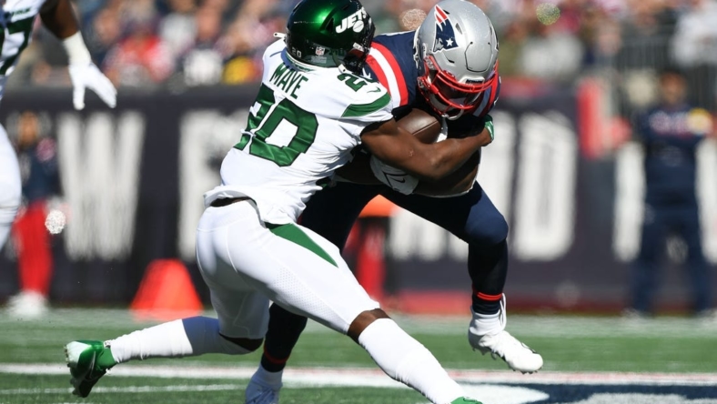 Oct 24, 2021; Foxborough, Massachusetts, USA; New York Jets free safety Marcus Maye (20) tackles New England Patriots running back Damien Harris (37) during the first half at Gillette Stadium. Mandatory Credit: Brian Fluharty-USA TODAY Sports