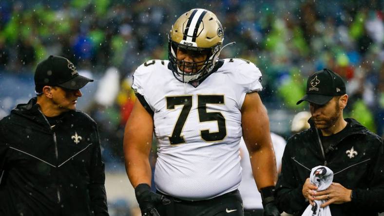 Oct 25, 2021; Seattle, Washington, USA; New Orleans Saints guard Andrus Peat (75) walks to the sideline following an injury during the second quarter against the Seattle Seahawks at Lumen Field. Mandatory Credit: Joe Nicholson-USA TODAY Sports