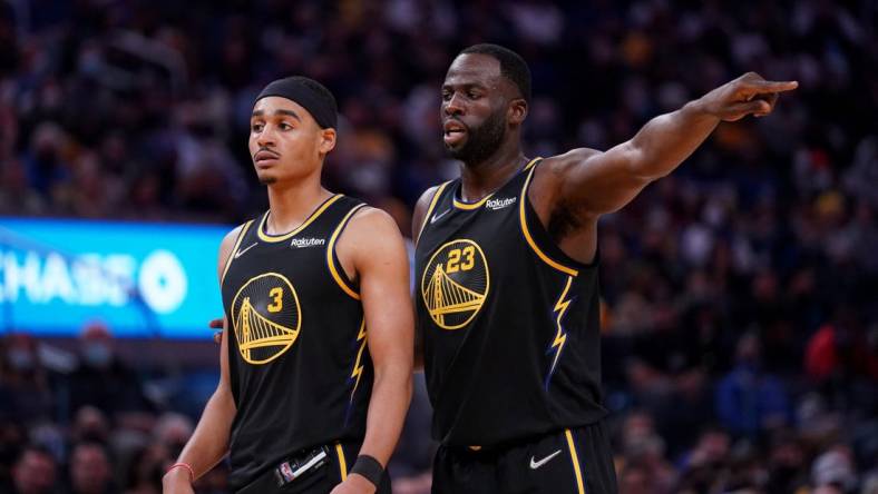 Nov 24, 2021; San Francisco, California, USA; Golden State Warriors forward Draymond Green (23) stands next to guard Jordan Poole (3) during action against the Philadelphia 76ers in the third quarter at the Chase Center. Mandatory Credit: Cary Edmondson-USA TODAY Sports