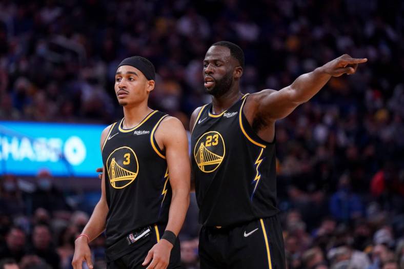 Nov 24, 2021; San Francisco, California, USA; Golden State Warriors forward Draymond Green (23) stands next to guard Jordan Poole (3) during action against the Philadelphia 76ers in the third quarter at the Chase Center. Mandatory Credit: Cary Edmondson-USA TODAY Sports