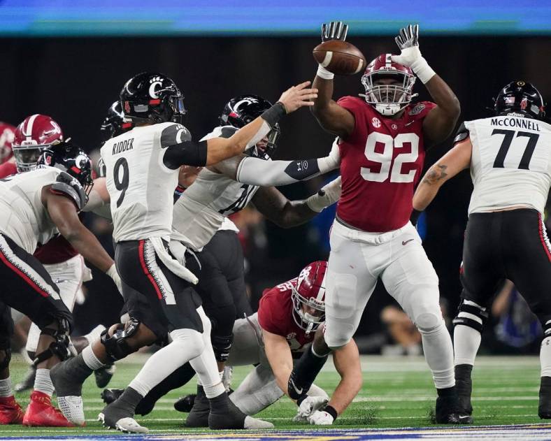 Alabama defensive lineman Justin Eboigbe (92) pressures Cincinnati quarterback Desmond Ridder (9) as he throws during the 2021 College Football Playoff Semifinal game at the 86th Cotton Bowl in AT&T Stadium in Arlington, Texas Friday, Dec. 31, 2021. Alabama defeated Cincinnati 27-6 to advance to the national championship game. [Staff Photo/Gary Cosby Jr.]

College Football Playoffs Alabama Vs Cincinnati