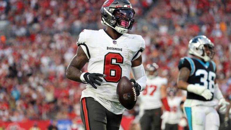 Jan 9, 2022; Tampa, Florida, USA; Tampa Bay Buccaneers running back Le'Veon Bell (6) runs the ball in for a touchdown against the Carolina Panthers during the first half at Raymond James Stadium. Mandatory Credit: Kim Klement-USA TODAY Sports