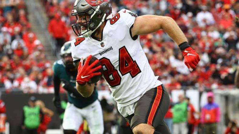 Jan 16, 2022; Tampa, Florida, USA; Tampa Bay Buccaneers tight end Cameron Brate (84) runs with the ball against the Philadelphia Eagles during the second half in a NFC Wild Card playoff football game at Raymond James Stadium. Mandatory Credit: Kim Klement-USA TODAY Sports