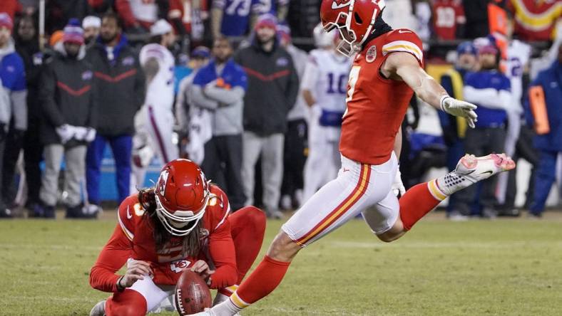 Jan 23, 2022; Kansas City, Missouri, USA; Kansas City Chiefs kicker Harrison Butker (7) kicks the point after touchdown against the Buffalo Bills during an AFC Divisional playoff football game at GEHA Field at Arrowhead Stadium. Mandatory Credit: Denny Medley-USA TODAY Sports