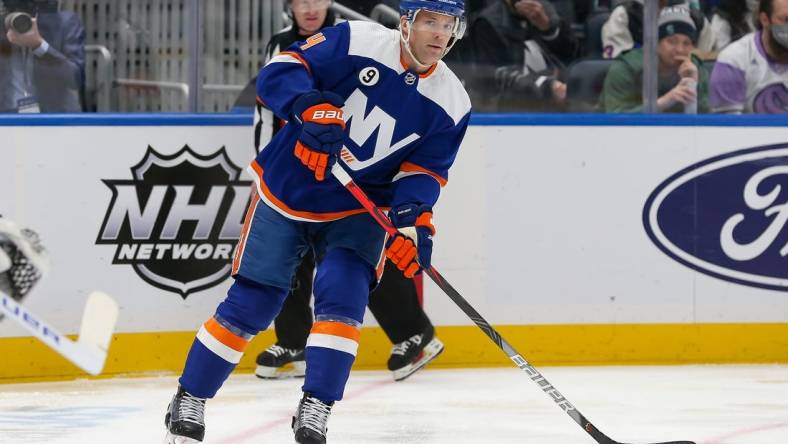 Feb 2, 2022; Elmont, New York, USA; New York Islanders defenseman Andy Greene (4) looks to pass against Seattle Kraken during the first period at UBS Arena. Mandatory Credit: Tom Horak-USA TODAY Sports