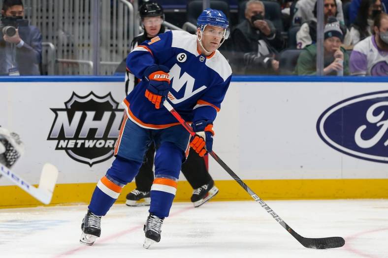 Feb 2, 2022; Elmont, New York, USA; New York Islanders defenseman Andy Greene (4) looks to pass against Seattle Kraken during the first period at UBS Arena. Mandatory Credit: Tom Horak-USA TODAY Sports