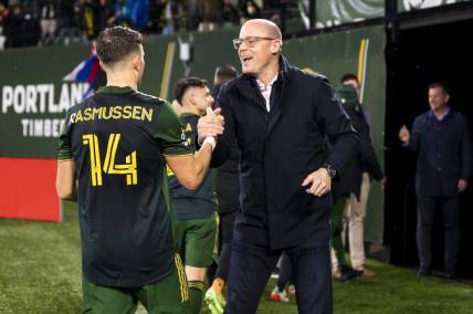 Mar 12, 2022; Portland, Oregon, USA; Portland Timbers defender Justin Rasmussen (14) celebrates with owner Merritt Paulson after a game against Austin FC at Providence Park. The Timbers won the game 1-0. Mandatory Credit: Troy Wayrynen-USA TODAY Sports