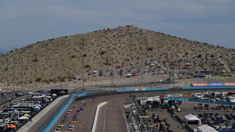 Mar 13, 2022; Avondale, Arizona, USA; General view as NASCAR Cup Series driver Kyle Busch (18) and driver Ryan Blaney (12) lead the field for the restart of the Ruoff Mortgage 500 at Phoenix Raceway. Mandatory Credit: Gary A. Vasquez-USA TODAY Sports