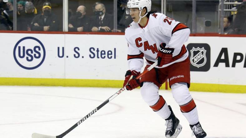 Mar 13, 2022; Pittsburgh, Pennsylvania, USA;  Carolina Hurricanes defenseman Ethan Bear (25) handles the puck against the Pittsburgh Penguins during the second period at PPG Paints Arena. Mandatory Credit: Charles LeClaire-USA TODAY Sports