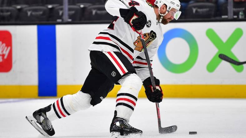 Mar 23, 2022; Anaheim, California, USA; Chicago Blackhawks defenseman Calvin de Haan (44) shoots on goal against the Anaheim Ducks during the first period at Honda Center. Mandatory Credit: Gary A. Vasquez-USA TODAY Sports