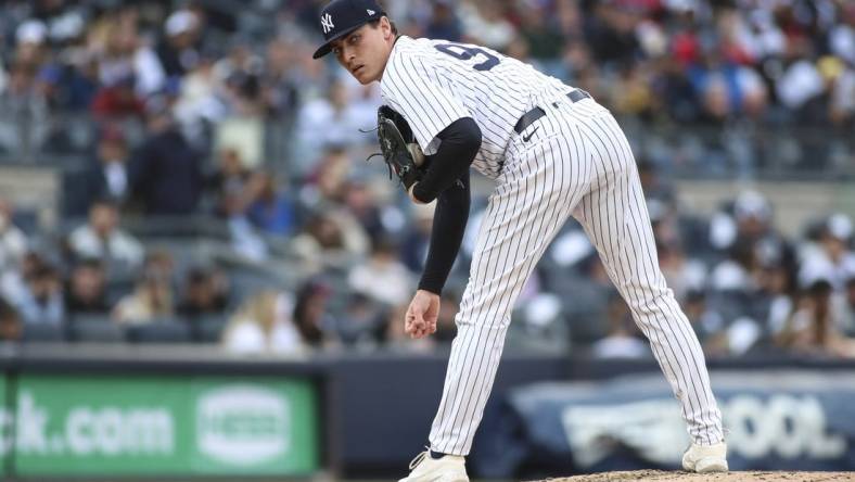 Apr 9, 2022; Bronx, New York, USA;  New York Yankees relief pitcher Ron Marinaccio (97) looks a runner back in the fourth inning against the Boston Red Sox at Yankee Stadium. Mandatory Credit: Wendell Cruz-USA TODAY Sports