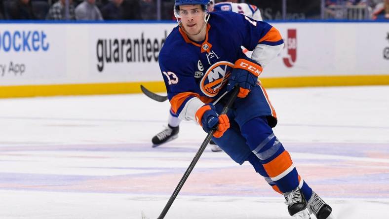 Apr 21, 2022; Elmont, New York, USA; New York Islanders center Mathew Barzal (13) skates across the blue line against the New York Rangers during the second period at UBS Arena. Mandatory Credit: Dennis Schneidler-USA TODAY Sports