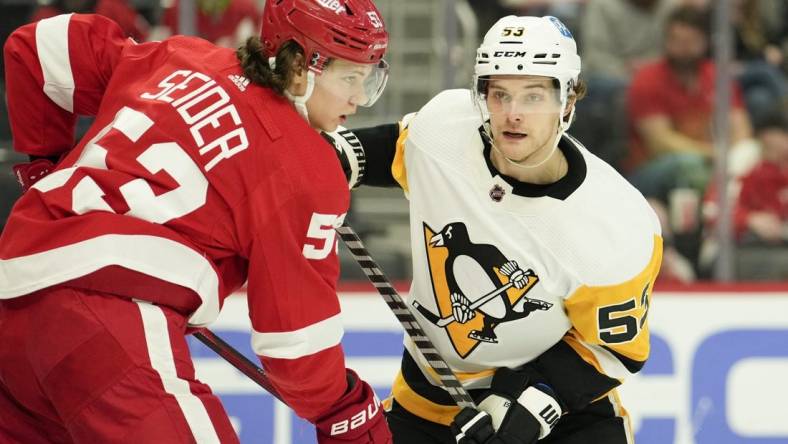 Apr 23, 2022; Detroit, Michigan, USA; Pittsburgh Penguins center Teddy Blueger (53) and Detroit Red Wings defenseman Moritz Seider (53) fight for position in front of the net during the third period at Little Caesars Arena. Mandatory Credit: Raj Mehta-USA TODAY Sports