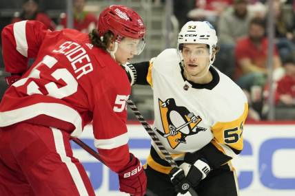 Apr 23, 2022; Detroit, Michigan, USA; Pittsburgh Penguins center Teddy Blueger (53) and Detroit Red Wings defenseman Moritz Seider (53) fight for position in front of the net during the third period at Little Caesars Arena. Mandatory Credit: Raj Mehta-USA TODAY Sports