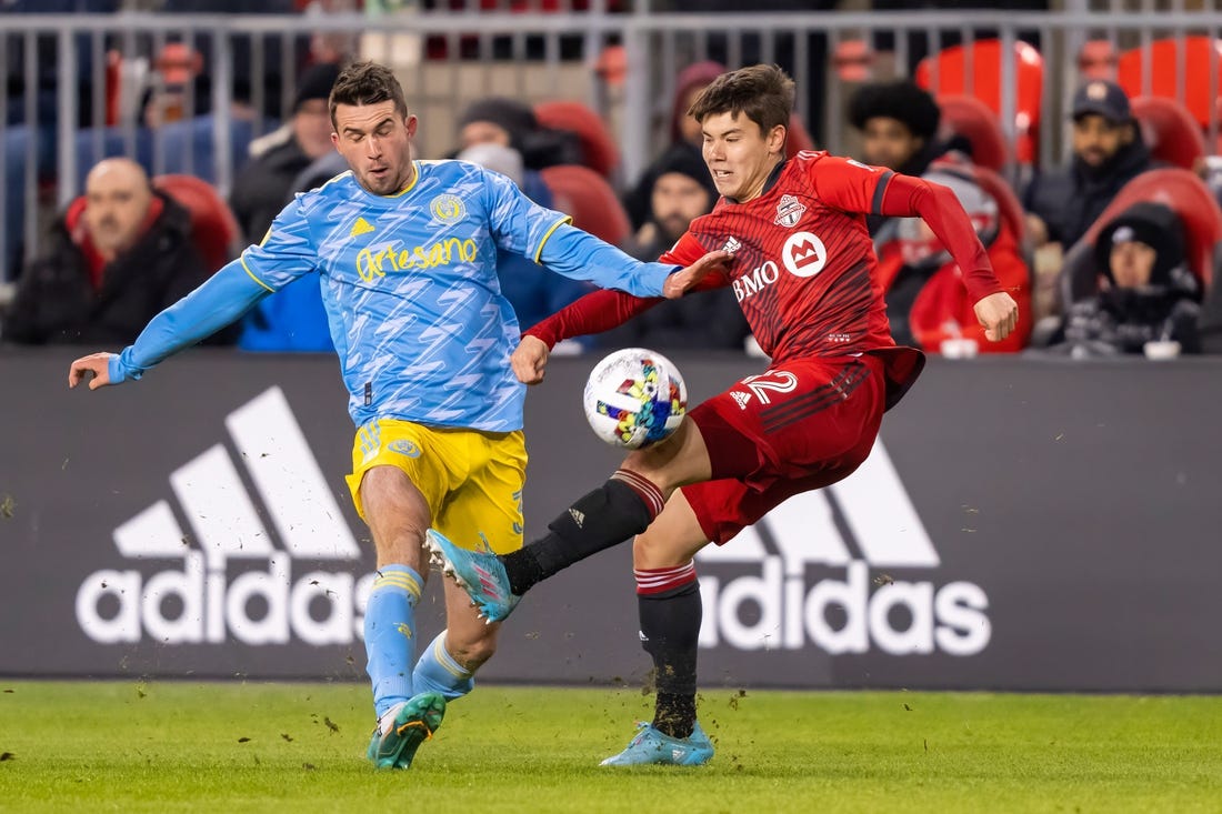 Apr 16, 2022; Toronto, Ontario, CAN; Toronto FC defender Kadin Chung (12) battles for the ball against Philadelphia Union defender Jack Elliott (3) at BMO Field. Mandatory Credit: Kevin Sousa-USA TODAY Sports