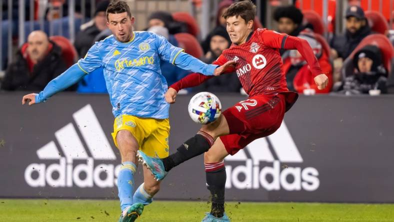 Apr 16, 2022; Toronto, Ontario, CAN; Toronto FC defender Kadin Chung (12) battles for the ball against Philadelphia Union defender Jack Elliott (3) at BMO Field. Mandatory Credit: Kevin Sousa-USA TODAY Sports