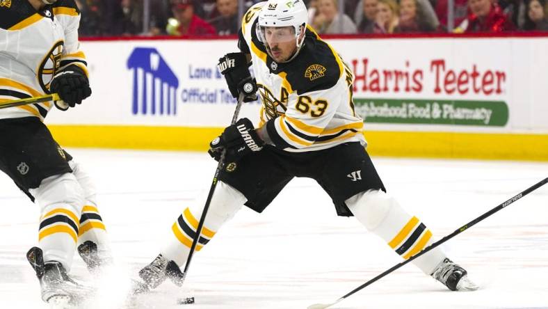 May 10, 2022; Raleigh, North Carolina, USA; Boston Bruins left wing Brad Marchand (63) skates with the puck against the Carolina Hurricanes during the second period in game five of the first round of the 2022 Stanley Cup Playoffs at PNC Arena. Mandatory Credit: James Guillory-USA TODAY Sports