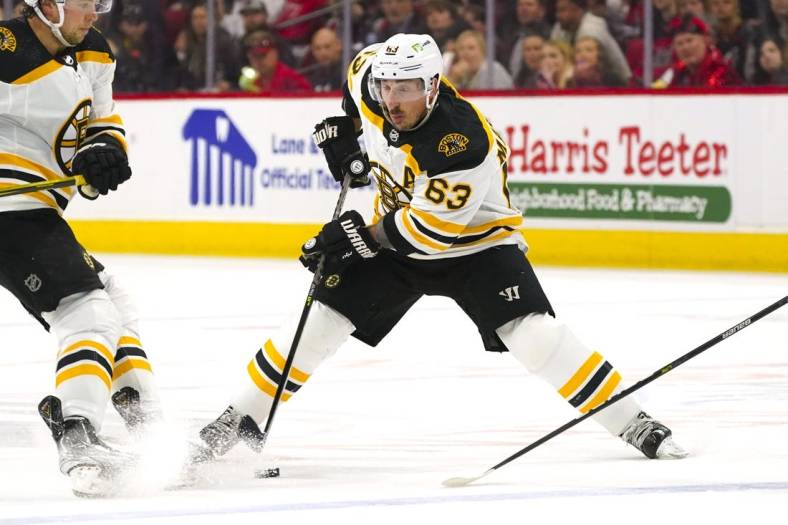 May 10, 2022; Raleigh, North Carolina, USA; Boston Bruins left wing Brad Marchand (63) skates with the puck against the Carolina Hurricanes during the second period in game five of the first round of the 2022 Stanley Cup Playoffs at PNC Arena. Mandatory Credit: James Guillory-USA TODAY Sports