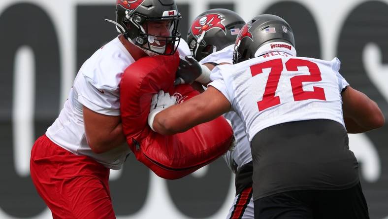 May 25, 2022; Tampa, FL, USA;  Tampa Bay Buccaneers  guard Luke Goedeke (67) (left) and tackle Josh Wells (72) participate in organized team activities at AdventHealth Training Center Mandatory Credit: Nathan Ray Seebeck-USA TODAY Sports