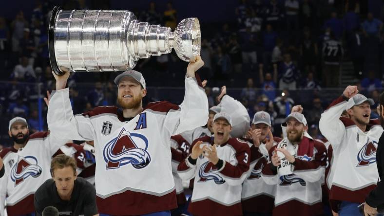 Jun 26, 2022; Tampa, Florida, USA; Colorado Avalanche center Nathan MacKinnon (29) celebrates with the Stanley Cup after the Avalanche game against the Tampa Bay Lightning in game six of the 2022 Stanley Cup Final at Amalie Arena. Mandatory Credit: Geoff Burke-USA TODAY Sports