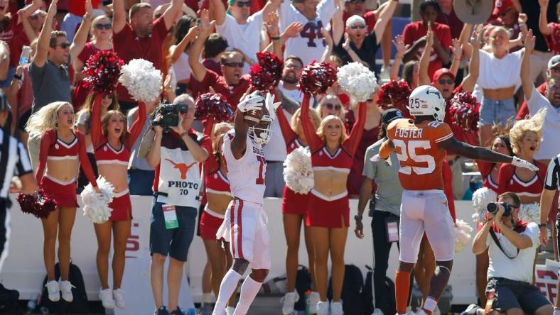 Oklahoma's Marvin Mims (17) celebrates beside Texas' B.J. Foster (25) after catching a pass for a touchdown during the Red River Showdown college football game between the University of Oklahoma Sooners (OU) and the University of Texas (UT) Longhorns at the Cotton Bowl in Dallas, Saturday, Oct. 9, 2021.  Oklahoma won 55-48.

cover main