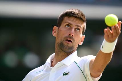 Jul 5, 2022; London, England, United Kingdom; Novak Djokovic (SRB) serves against Jannik Sinner (ITA) during a quarterfinals mens singles match on Centre court at the 2022 Wimbledon Championships at All England Lawn Tennis and Croquet Club. Mandatory Credit: Peter van den Berg-USA TODAY Sports