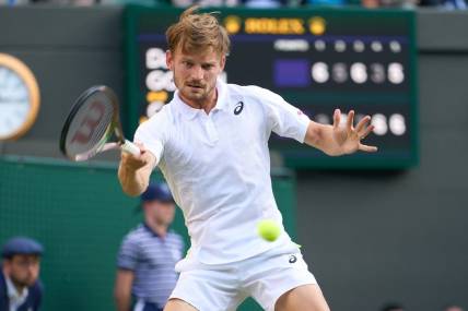 Jul 5, 2022; London, England, United Kingdom; David Goffin (BEL) returns a shot against Cameron Norrie (GBR) during a quarterfinals mens singles match on Number one court at the 2022 Wimbledon Championships at All England Lawn Tennis and Croquet Club. Mandatory Credit: Peter van den Berg-USA TODAY Sports