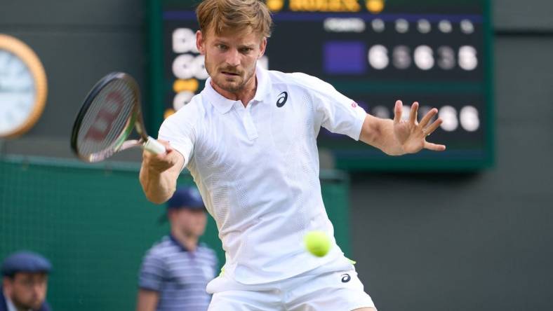 Jul 5, 2022; London, England, United Kingdom; David Goffin (BEL) returns a shot against Cameron Norrie (GBR) during a quarterfinals mens singles match on Number one court at the 2022 Wimbledon Championships at All England Lawn Tennis and Croquet Club. Mandatory Credit: Peter van den Berg-USA TODAY Sports