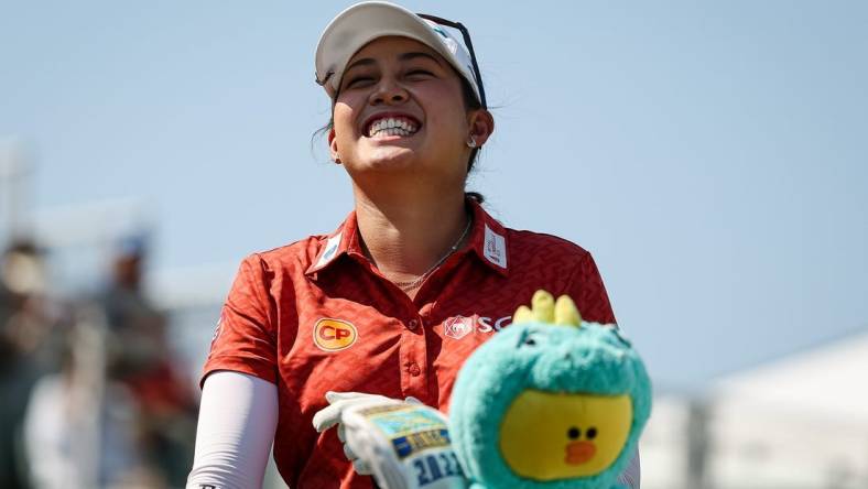 Jun 26, 2022; Bethesda, Maryland, USA; Atthaya Thitikul laughs from the first tee during the final round of the KPMG Women's PGA Championship golf tournament at Congressional Country Club. Mandatory Credit: Scott Taetsch-USA TODAY Sports