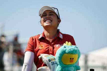 Jun 26, 2022; Bethesda, Maryland, USA; Atthaya Thitikul laughs from the first tee during the final round of the KPMG Women's PGA Championship golf tournament at Congressional Country Club. Mandatory Credit: Scott Taetsch-USA TODAY Sports