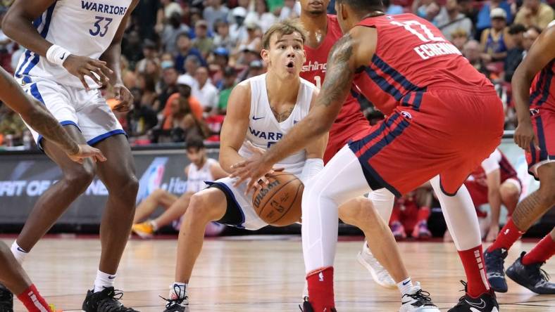 Jul 17, 2022; Las Vegas, NV, USA; Golden State Warriors guard Mac McClung (55) looks to shoot past Washington Wizards center Jaime Echenique (12) during a NBA Summer League game at Thomas & Mack Center. Mandatory Credit: Stephen R. Sylvanie-USA TODAY Sports