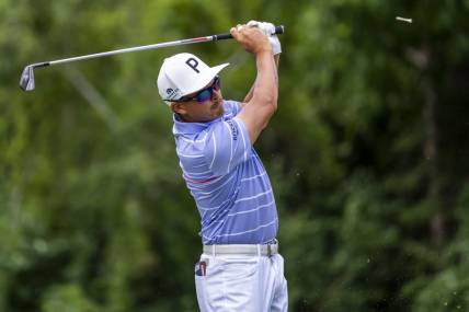 Jul 29, 2022; Detroit, Michigan, USA; Rickie Fowler hits his tee shot on the par 3 ninth hole during the second round of the Rocket Mortgage Classic golf tournament. Mandatory Credit: Raj Mehta-USA TODAY Sports