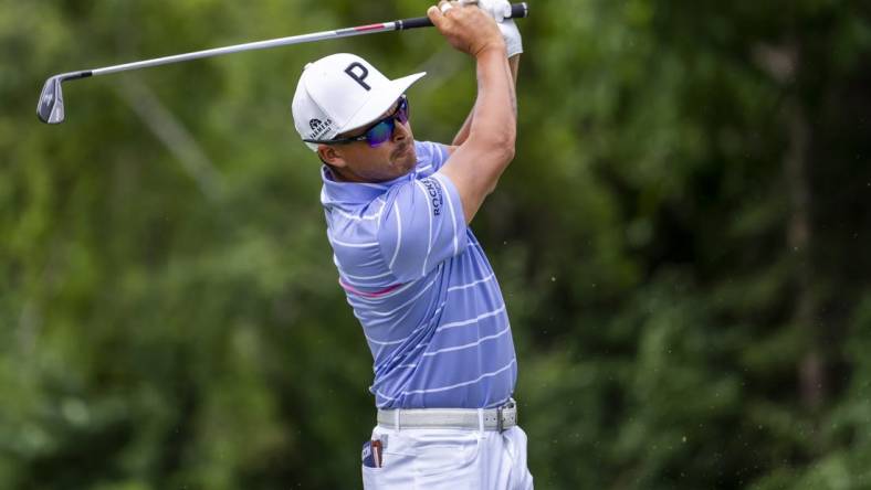 Jul 29, 2022; Detroit, Michigan, USA; Rickie Fowler hits his tee shot on the par 3 ninth hole during the second round of the Rocket Mortgage Classic golf tournament. Mandatory Credit: Raj Mehta-USA TODAY Sports