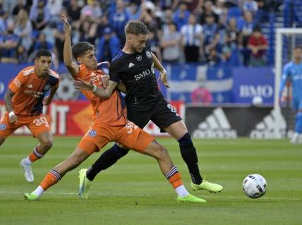 Jul 30, 2022; Montreal, Quebec, CAN; New York City FC midfielder Gabriel Pereira dos Santos (38) and CF Montreal midfielder Djordje Mihailovic (8) battle for the ball during the first half at Stade Saputo. Mandatory Credit: Eric Bolte-USA TODAY Sports