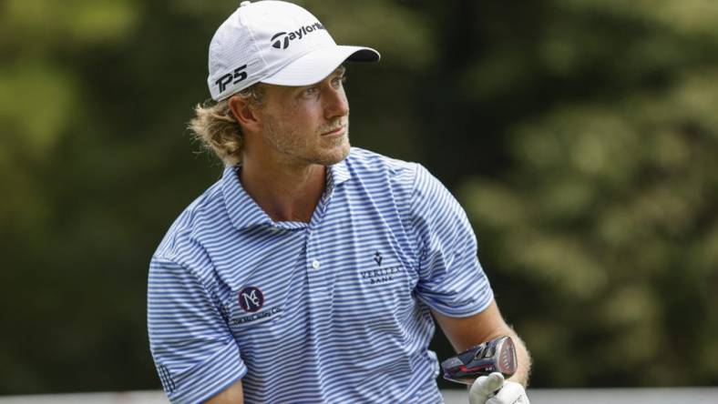 Aug 4, 2022; Greensboro, North Carolina, USA; Austin Smotherman watches his tee shot on the 18th tee during the first round of the Wyndham Championship golf tournament. Mandatory Credit: Nell Redmond-USA TODAY Sports