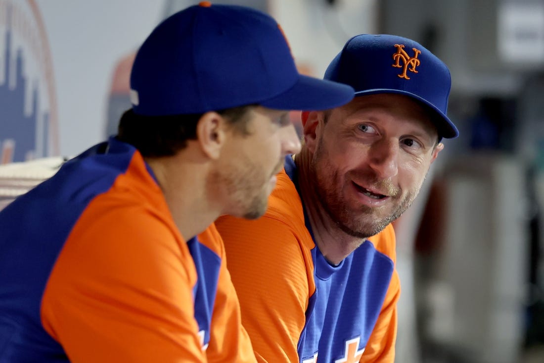 Aug 4, 2022; New York City, New York, USA; New York Mets starting pitchers Jacob deGrom (left) and Max Scherzer talk in the dugout during the ninth inning against the Atlanta Braves at Citi Field. Mandatory Credit: Brad Penner-USA TODAY Sports